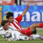 Real Madrid's Ronaldo grimaces as Almeria's Vargas falls on him during their Spanish first division soccer match at the Mediterraneo stadium in Almeria Real Madrid's Ronaldo grimaces as Almeria's Vargas falls on him during their Spanish first division soccer match at the Mediterraneo stadium in Almeria